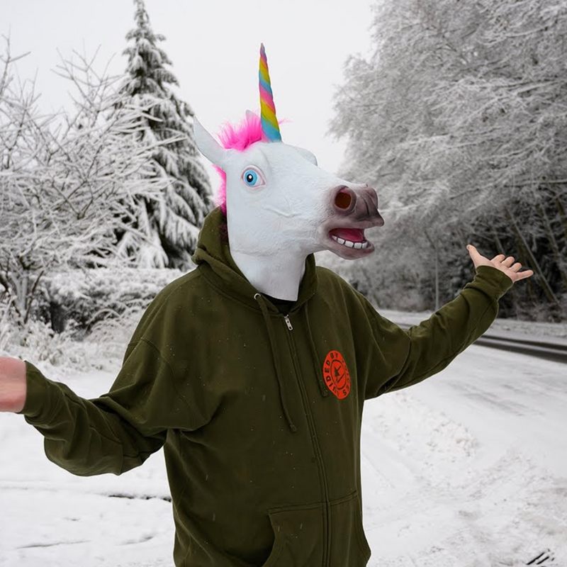 Man in unicorn mask surrounded by snow and shrugging