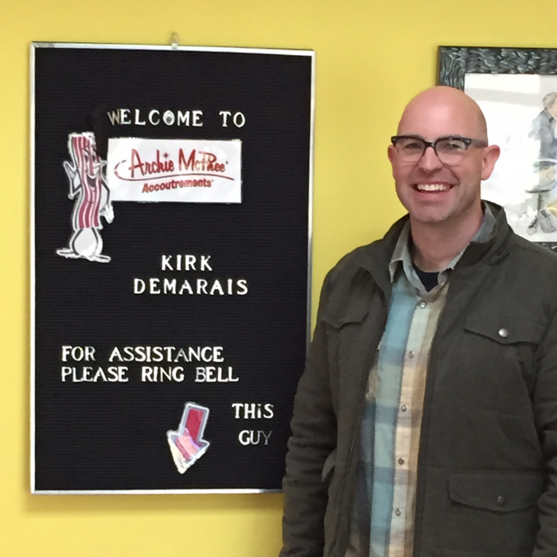 Kirk demarais in front of welcome sign