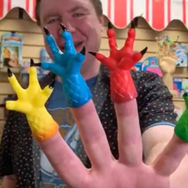 David Wahl wearing monster hand finger puppets