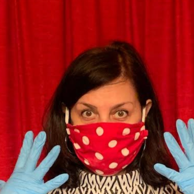 Shana wearing gloves and wearing a red mask