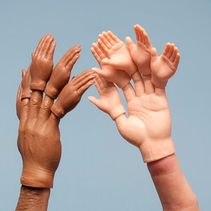 Two hands wearing finger hands wearing tinier finger hands