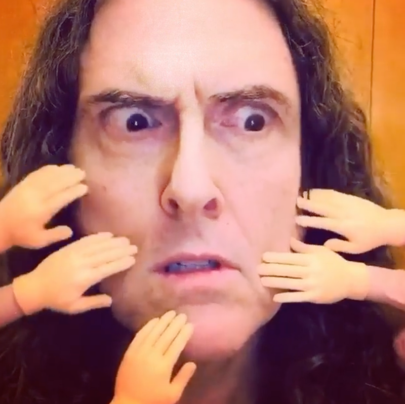 Weird Al surrounded by finger hands