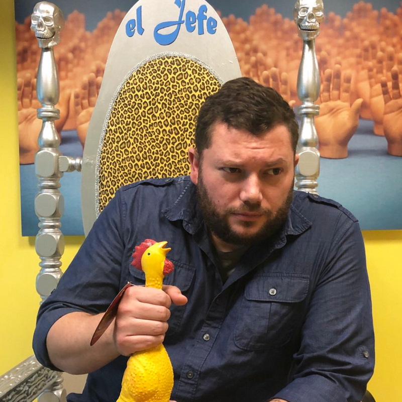 Scott Heff in throne holding a rubber chicken