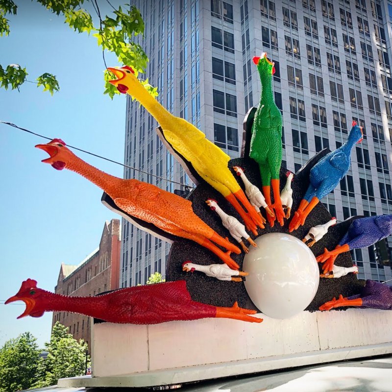 Rainbow of rubber chickens on top of a van