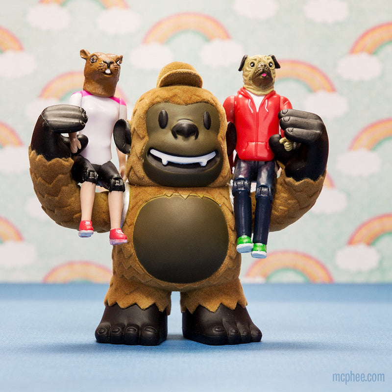 Mailchimp chimp mascot holding two strange friends action figures