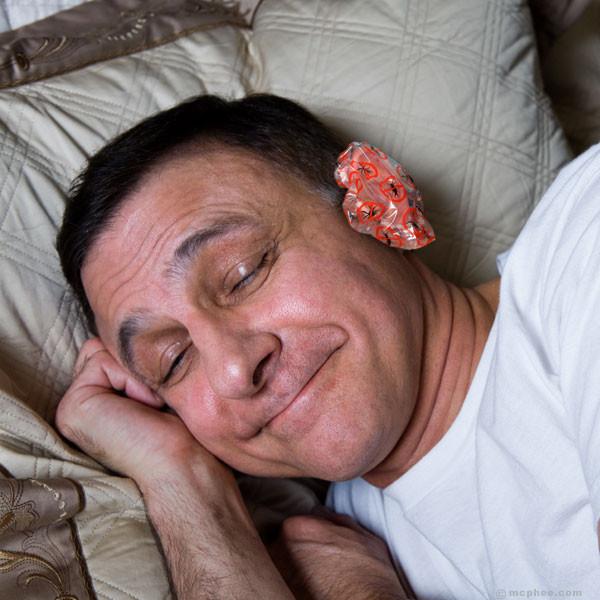 Man sleeping while wearing ear guards