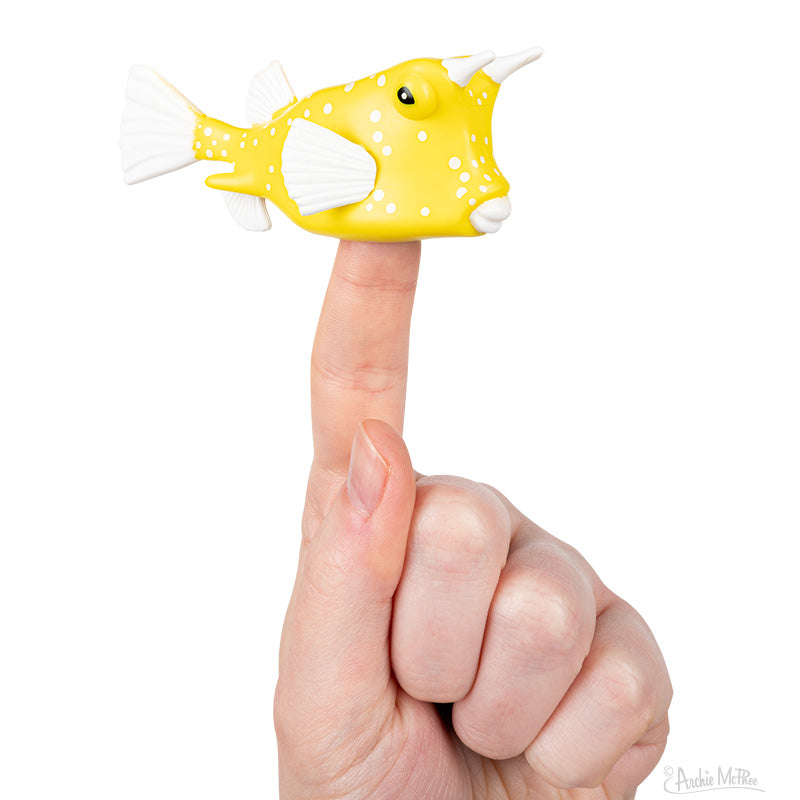 Yellow Cowfish Finger Puppet on a finger