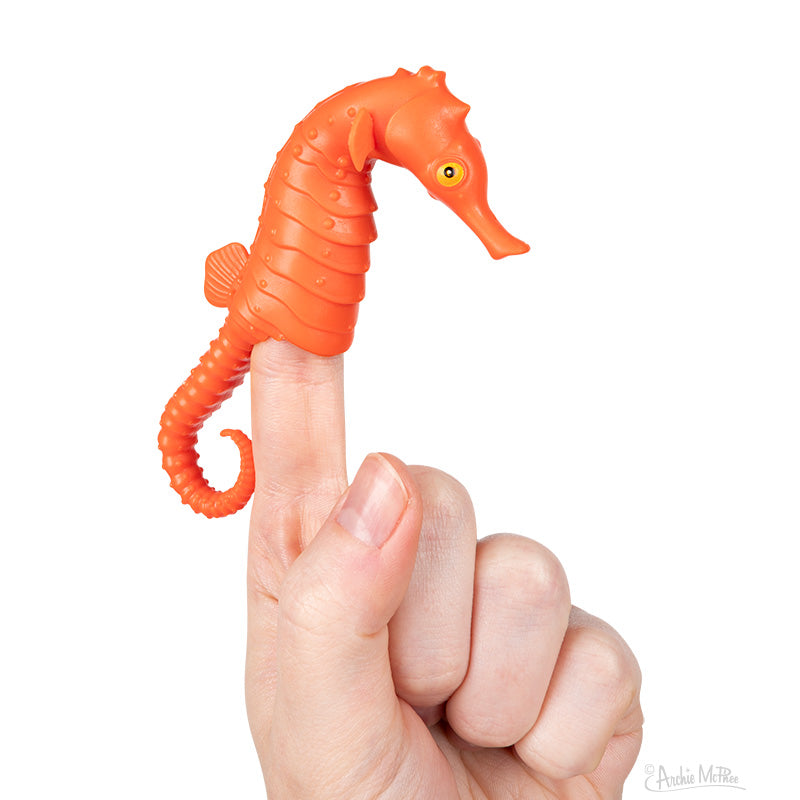 Orange Seahorse Finger Puppet on a finger