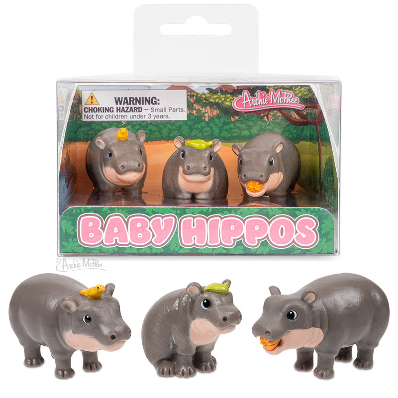 Three cute Baby Hippos figurines with tiny accessories including a pumpkin and leaves in clear packaging.