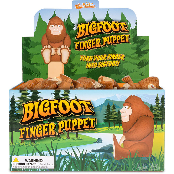 Bigfoot Finger Puppet display box featuring cartoon Sasquatch in forest setting, with "Turn your finger into Bigfoot" slogan and product images showing soft vinyl puppets in seated position