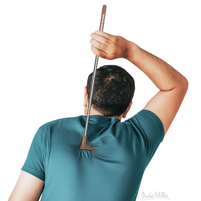 Man scratching his back with an extended Bigfoot Back Scratcher featuring a giant foot design handle
