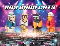 Four stylized cat figurines dressed as boy band members on a stage with colorful spotlights and a disco ball, showcasing the Boy Band Cats product inspired by 90s pop groups