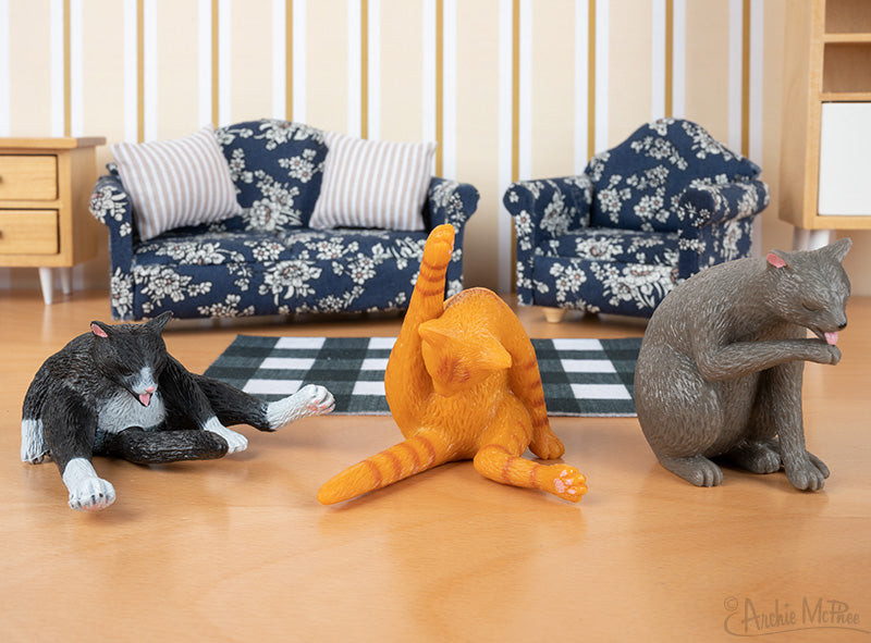 Three Cleaning Kitties posed in a scene with miniature furniture