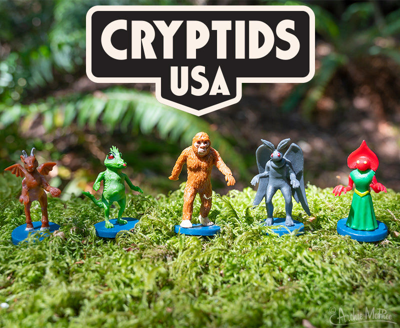 Box of Cryptids USA toy figures featuring mythical creatures in a forest setting.