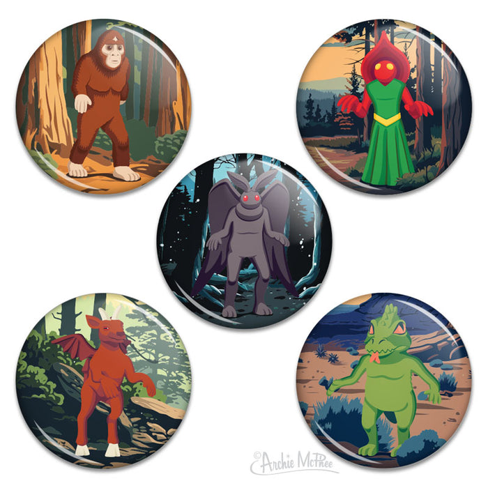 Five pin-back buttons featuring Jersey Devil, Chupacabra, Mothman, the Flatwoods Monster and Bigfoot each against a forest background.