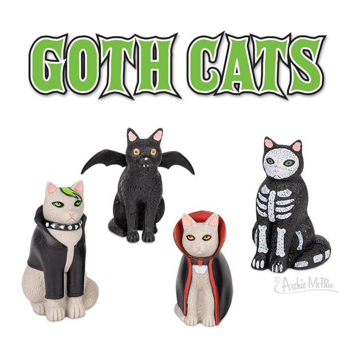 Goth Cats vinyl figurines featuring four unique designs: emo cat with leather jacket, bat-winged black cat, vampire cat in cape, and skeleton cat. Green gothic-style text reads "GOTH CATS" above the figurines.