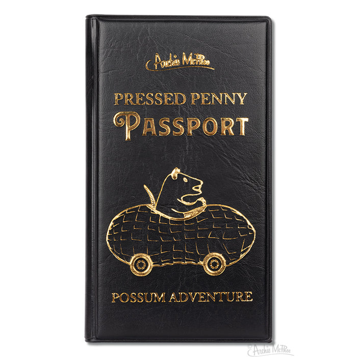 Black leather passport cover with gold lettering featuring "Pressed Penny Passport" and an illustration of a possum driving a peanut-shaped car, titled "Possum Adventure" for storing collectible pressed pennies