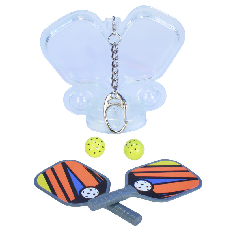 Miniature pickleball  paddle set with two paddles and balls and a clear plastic carrying case attached to a small keyring