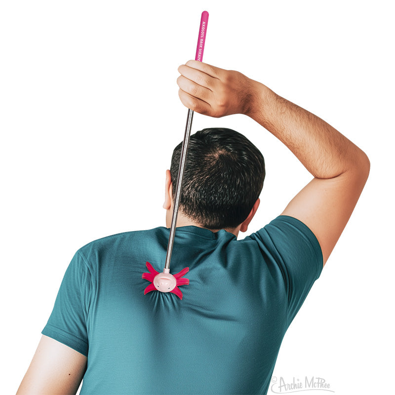 Man using a pink Axolotl Back Scratcher with an extended telescopic handle to scratch his back easily