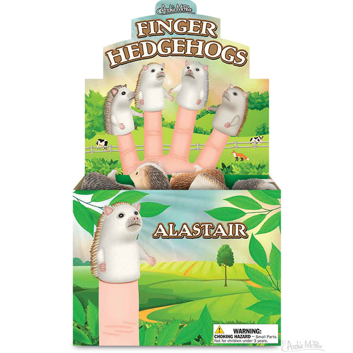 Colorful display box of Finger Hedgehogs featuring adorable hedgehog finger puppets in various colors, shown on human fingers against a cheerful farm background. Product name and warning label visible on packaging.