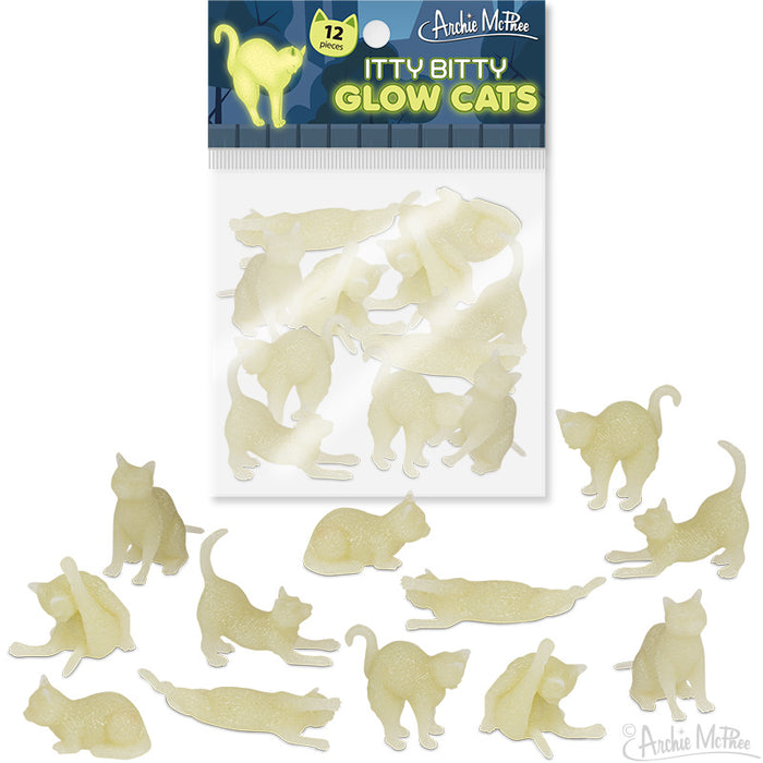 Bag of 12 Itty Bitty Glow Cats by Archie McPhee, featuring tiny glow-in-the-dark vinyl cat figurines in various poses. Product packaging shows a clear bag with cat shapes inside, surrounded by scattered glowing cat figures in playful positions.