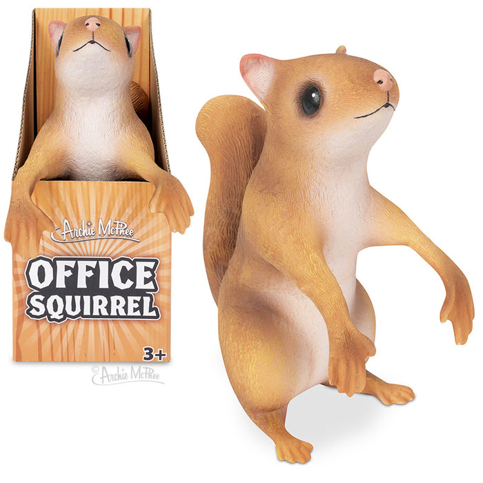 Posable Office Squirrel toy with bendable arms, sitting upright next to its product packaging. Tan-colored squirrel figurine with expressive face and detailed features, designed for desktop companionship and workplace humor.