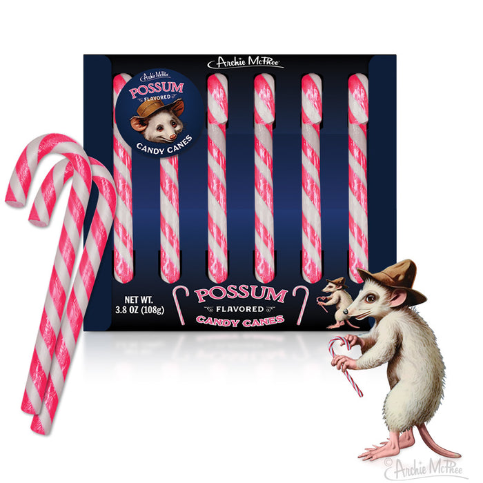 Novelty possum-flavored candy canes in pink and gray stripes, packaged in a dark blue box with cartoon possum illustrations. One candy cane stands out from the pack, showcasing the unique striped design.