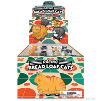 Display box of Racing Bread Loaf Cats toys featuring lounging and racing theme graphics with various cat breeds, all crafted from vinyl and plastic.