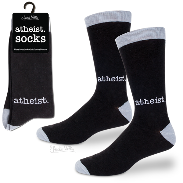 Black dress socks with 'atheist' printed in white text, displayed on packaging and as a pair. Contrasting white heel, toe, and top band. Product packaging shows 'atheist socks' branding on a black background.