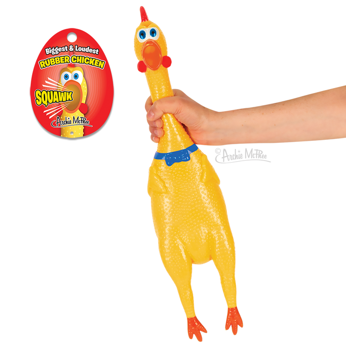 Large yellow rubber chicken toy with blue collar held by hand, next to product packaging featuring "Biggest & Loudest Rubber Chicken" text and cartoon chicken face