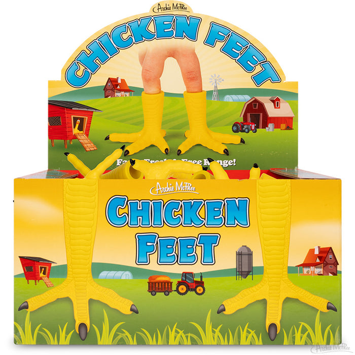 Colorful display box for Chicken Feet finger puppets, featuring cartoon farm scenery and bright yellow chicken feet designs. Product showcases soft vinyl puppets in a whimsical, farm-themed packaging for bulk purchase.