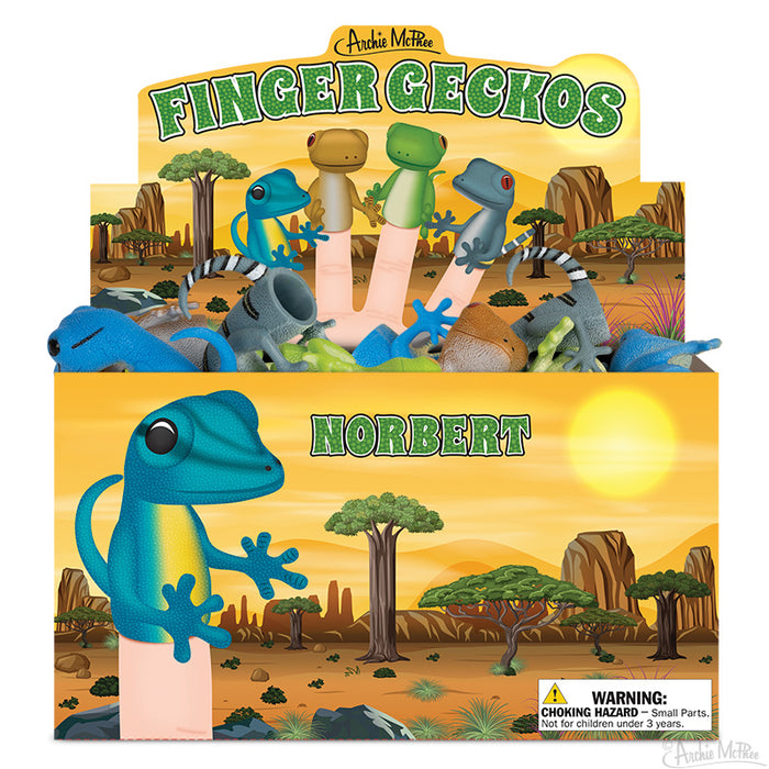 Colorful display box of Finger Geckos toy puppets, featuring various gecko designs in different colors. Box shows desert landscape with cacti and sun. Finger puppets visible inside, with one large blue gecko puppet prominently displayed in front.