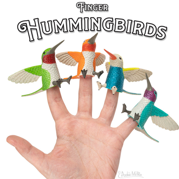 Set of four colorful hummingbird finger puppets on a hand, featuring vibrant designs with spread wings in various poses. Product title "Finger Hummingbirds" displayed above the image.