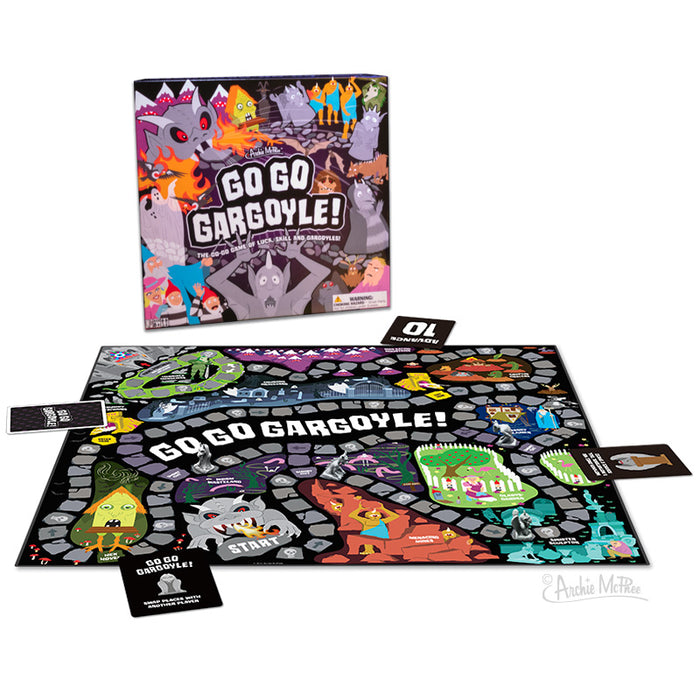 Go Go Gargoyle board game box and colorful game board featuring whimsical characters, castles, and magical elements. The game includes cards and gargoyle tokens for an adventure-filled gameplay experience through a fantastical kingdom.