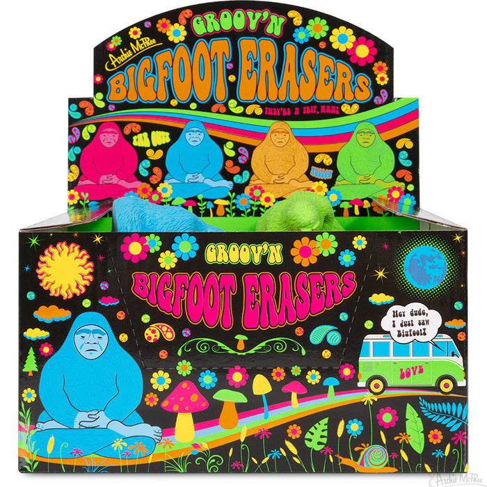 Colorful display box of Groov'n Bigfoot Erasers featuring psychedelic artwork, 2-inch vinyl figures in vibrant colors, and retro-inspired designs with flowers, mushrooms, and a hippie van, perfect for a fun and nostalgic office or school supply