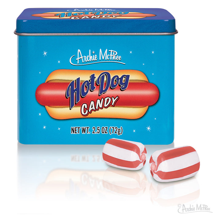 Archie McPhee Hot Dog Candy tin with colorful packaging featuring hot dog illustration, alongside red and white striped candies resembling miniature hot dogs