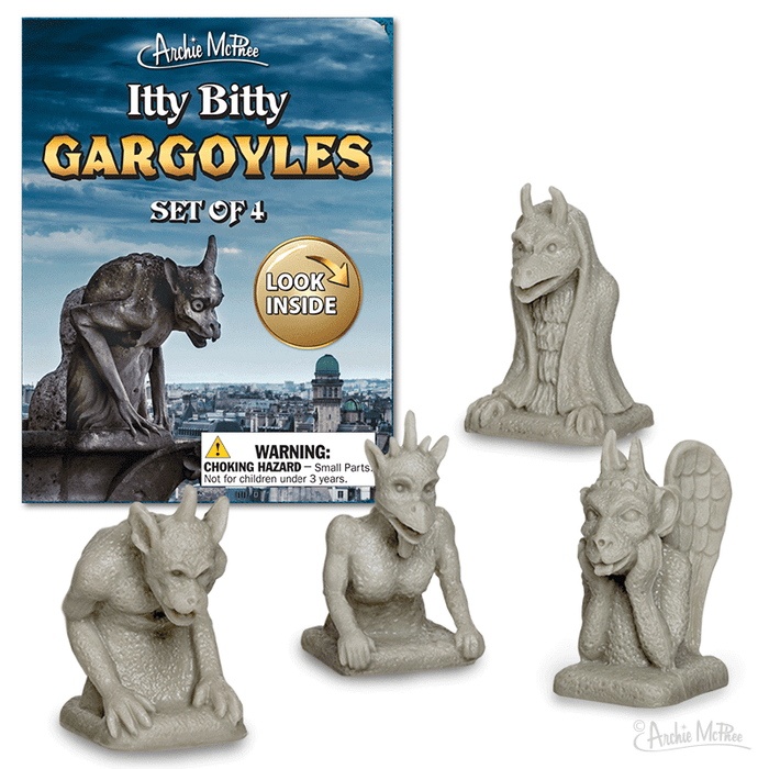 Itty Bitty Gargoyles set of 4 miniature figurines with product packaging featuring a stormy sky and cityscape. Small grey gargoyle statues in various poses, perfect for desktop protection and decoration. Compact size for apartments or office spaces.