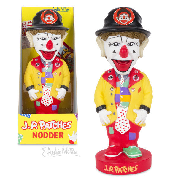 J.P. Patches Nodder figurine in colorful clown attire, featuring a yellow jacket, polka dot tie, and black hat. Boxed and unboxed versions shown side-by-side, highlighting the detailed design of this beloved Seattle children's TV show character.