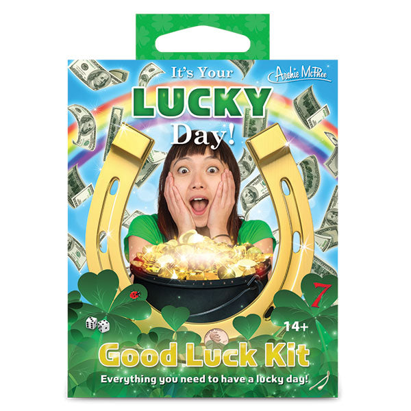 Colorful product packaging for "It's Your Lucky Day! Good Luck Kit" featuring horseshoe, rainbow, floating money, pot of gold, and clovers. Designed to bring luck and excitement for a fun, fortune-filled experience.