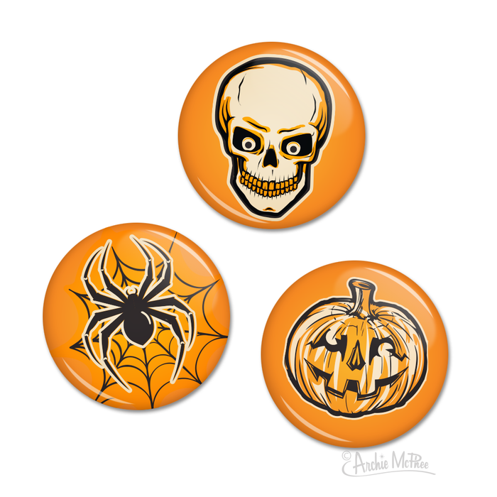 Set of three round Halloween buttons featuring retro designs on orange backgrounds: a grinning skull, a spider on a web, and a jack-o'-lantern pumpkin. Each button measures 1-1/4 inches in diameter, perfect for displaying Halloween spirit on clothing or accessories.