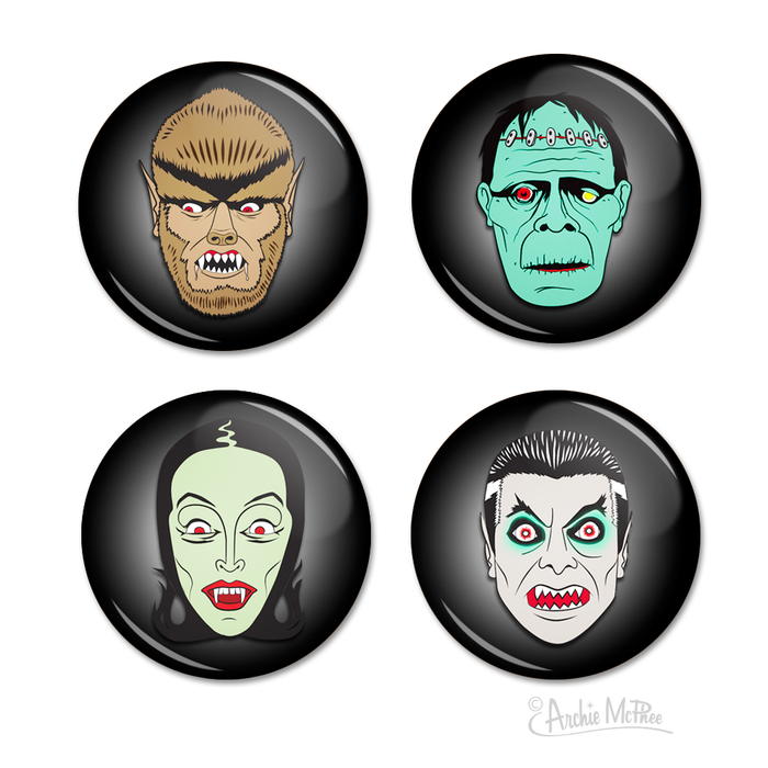 Four circular buttons featuring classic monster faces: werewolf, Frankenstein's monster, female vampire, and male vampire. Each button has a black background with the monster's face in vivid colors and distinctive features, creating a spooky yet fun Halloween-themed set.