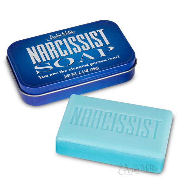 Blue tin containing Narcissist Soap with white text, alongside a light blue soap bar with 'NARCISSIST' embossed, showcasing unique self-centered cleaning product for those who believe they're the cleanest.