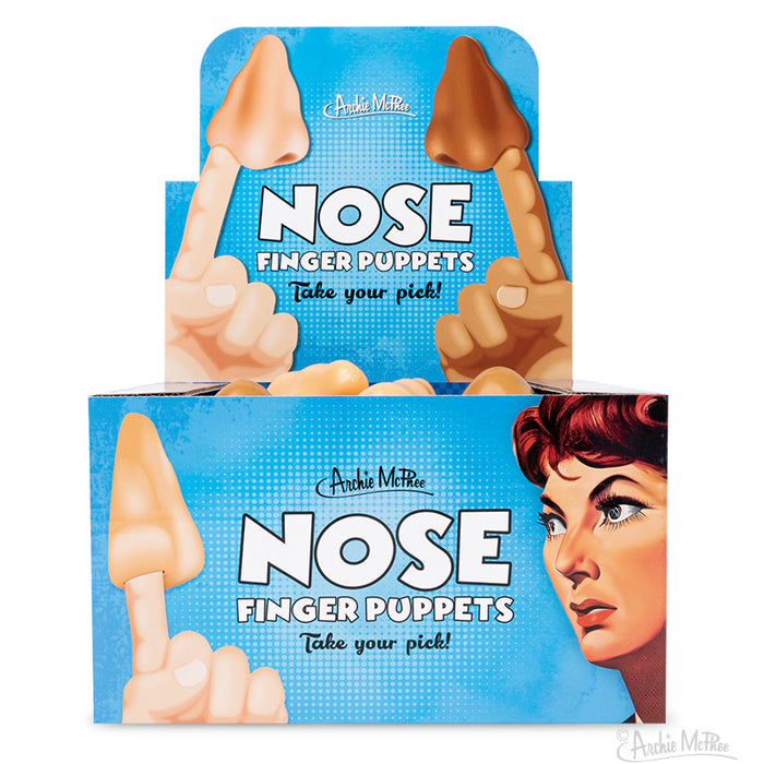 Display box of Nose Finger Puppets by Archie McPhee, featuring two colors of soft vinyl noses. Box shows cartoon hands demonstrating use and product name "NOSE FINGER PUPPETS" with tagline "Take your pick!" on blue background.