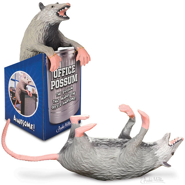 Realistic stuffed possum toy in two positions: sitting on product box and lying on its back. Box features "Office Possum" text and image of possum on computer. Possum has detailed gray fur, pink paws, and open mouth showing teeth.