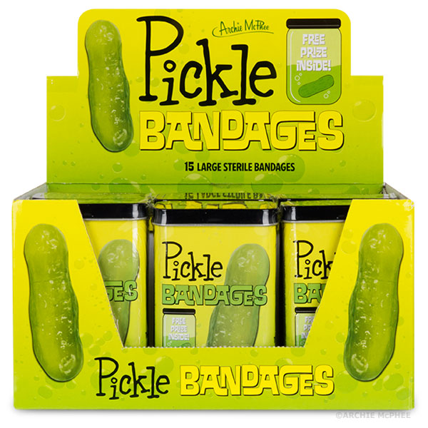 Display box of Pickle Bandages featuring bright yellow packaging with green pickle illustrations. Contains multiple tins of 15 large sterile bandages each, perfect for bulk purchase or promotional purposes.