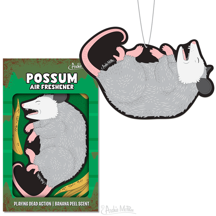 Possum-shaped air freshener with banana scent, hanging design and product packaging showing playful 'playing dead' possum illustration next to banana peels