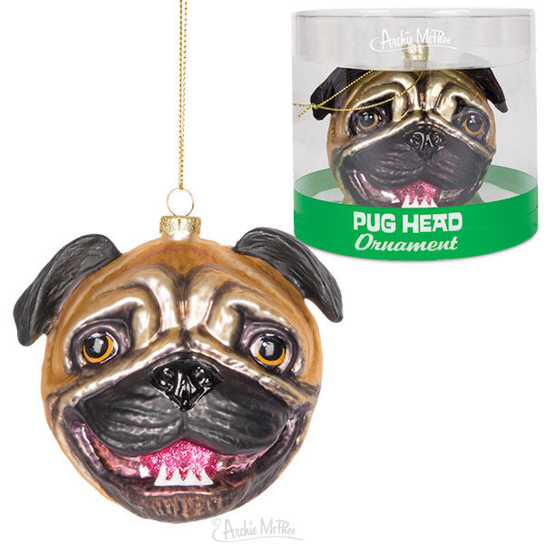 Glass pug head Christmas ornament with wrinkled face and pink tongue, shown hanging and in green-based packaging, capturing the breed's unique features for holiday decoration