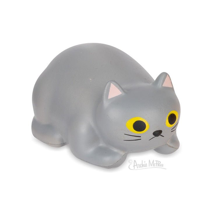 Purrrly Kitty stress relief toy, gray cat-shaped foam figure with yellow eyes and pink ears, lying in relaxed pose, perfect for squeezing to relieve stress