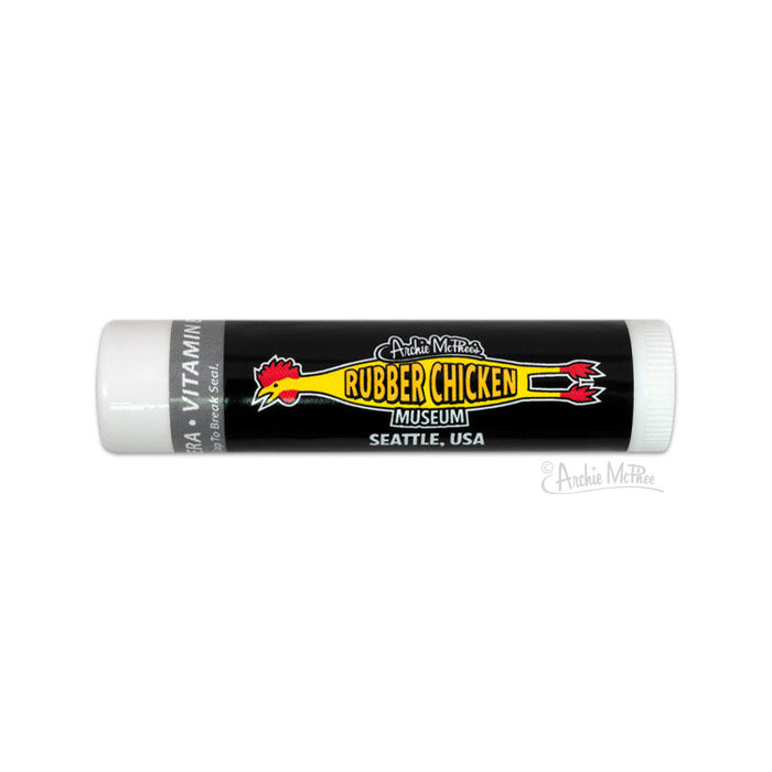 Rubber Chicken Museum lip balm tube featuring black label with yellow text and red chicken logo, from Seattle's Archie McPhee store, huckleberry flavored, 1-3/4 inches long