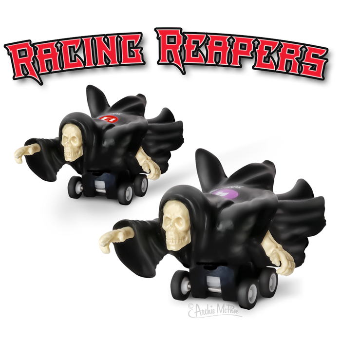 Racing Reapers toy set featuring two pull-back skeleton figures in black hooded cloaks, with outstretched arms and wheels, against a white background. Red text logo "Racing Reapers" above the toys.